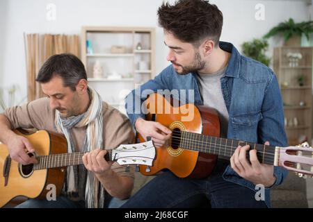 due uomini che si incastrano con le chitarre Foto Stock