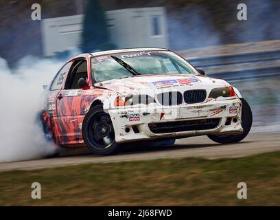 Sport auto ruota drifting. Sfocata immagine di diffusione deriva di gara di auto con un sacco di fumo dalla combustione di pneumatici su pista di velocità. Sport concetto,Drifting auto c Foto Stock