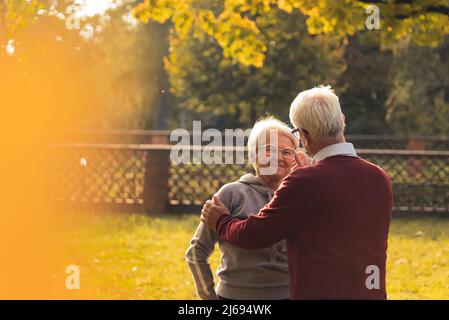 Persone sposate di mezza età in piedi nel parco caduta mezzo colpo copia spazio anziani supporto . Foto di alta qualità Foto Stock