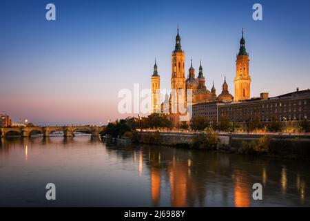 Basilica del Pilar Cattedrale con ponte in pietra che attraversa il fiume Ebro al tramonto, Saragozza, Aragona, Spagna, Europa Foto Stock