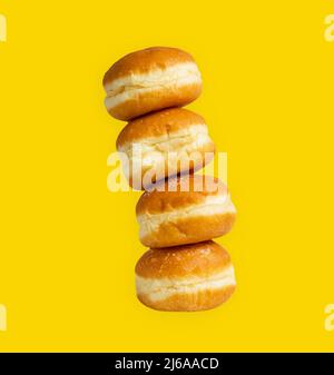 Ciambelle austriache e tedesche o krapfen. Berliner con crema. Su sfondo giallo Foto Stock