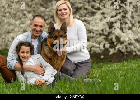 Famiglia felice di fare un picnic in natura. Una famiglia sorridente che picnic nel parco. Natura primaverile Foto Stock
