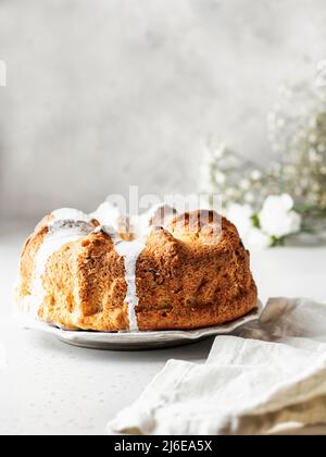 Bella torta soffice decorata con glassa. Ancora vita con tovaglioli e fiori di lino Foto Stock