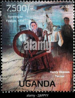 'Spinning by firewlight' di Henry Ossawa Tanner su timbro Foto Stock