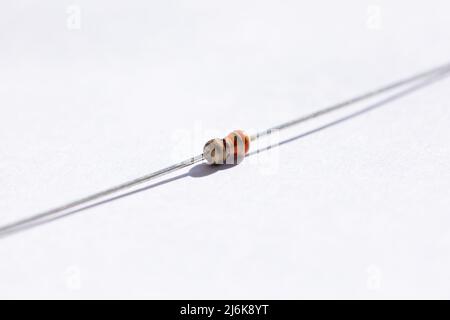 Ritratto in primo piano di un resistore da 330 ohm con una tolleranza del 5%. Il componente elettrico è isolato su sfondo bianco ed è pronto per essere utilizzato in un Foto Stock