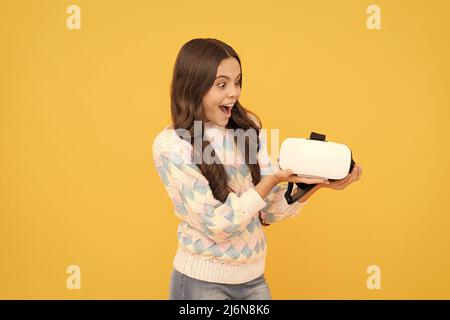Tecnologia wireless moderna. Sviluppo infantile. Stupito teen girl tenere occhiali wireless VR. Foto Stock