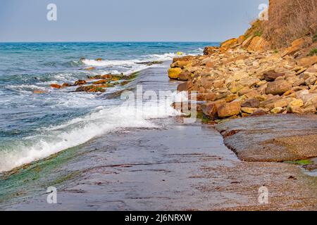 La marea scorre e sommerge la stretta passerella costiera a Peveril Point Swanage Inghilterra Foto Stock