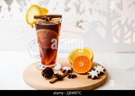 Bevanda calda, VIN brulé rosso in una tazza di bicchiere su sfondo di legno. Foto Stock