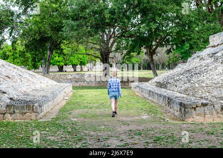 Una donna turistica che esplora le rovine del campo da ballo dell'antica città maya di Edzna - famoso sito archeologico vicino a Campeche, penisola dello Yucatan, Messico Foto Stock