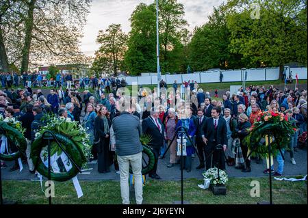 Si vede la gente che guarda le corone di fiori lasciate dopo la cerimonia. In questo giorno, in tutto il paese, si svolgono cerimonie per commemorare civili e soldati in tutto il mondo durante la seconda guerra mondiale e altri conflitti. A Nijmegen si è svolta una cerimonia all'interno della Chiesa di Santo Stefano, da lì una processione silenziosa ha preso le strade per il 'Keizer Traianusplein', dove due monumenti in ricordo delle vittime della seconda Guerra Mondiale Alzati. La cerimonia ufficiale è iniziata con due minuti di silenzio, dopo di che il sindaco di Nijmegen Hubert Bruls ha tenuto un discorso ricordando le vittime e la fa Foto Stock