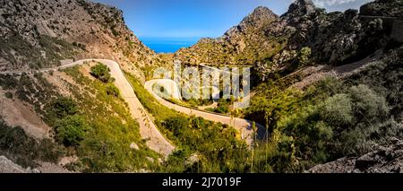 Ampio panorama della serpentina delle baleari ma-2141 che si snoda verso sa calobra attraverso una valle nella zona del coll dels reis di Maiorca. Foto Stock