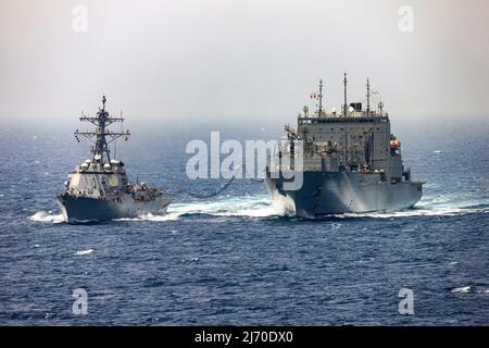 220503-N-TT059-2001 MARE ARABICO (03 maggio 2022) il cacciatorpediniere missilistico guidato USS Momsen (DDG 92) conduce un rifornimento-in-mare con carico asciutto e nave di munizioni USNS Charles Drew (T-AKE 10) nel Mare Arabico, maggio 3. Momsen è schierata nell'area operativa della flotta USA 5th per contribuire a garantire la sicurezza e la stabilità marittima nella regione del Medio Oriente. (STATI UNITI Foto Navy di Mass Communication Specialist 3rd Classe Lily Gebauer) Foto Stock