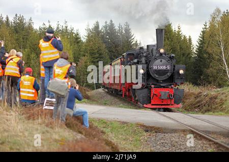 05 maggio 2022, Sassonia-Anhalt, Benneckenstein: I fotografi si trovano sulla linea ferroviaria vicino a Benneckenstein e attendono il treno speciale della Harzer Schmalspurbahn GmbH, trainato dalla locomotiva Mallet 99 5906. Si tratta dell'ultimo mazzetto operativo di questo tipo in esecuzione sull'HSB. A 104 anni di età, è ora in pensione. A partire da oggi, ci sarà una serie di viaggi speciali come tour di addio per la locomotiva a vapore. A partire da metà maggio, la locomotiva non sarà più utilizzata. Foto: Matthias Bein/dpa Foto Stock