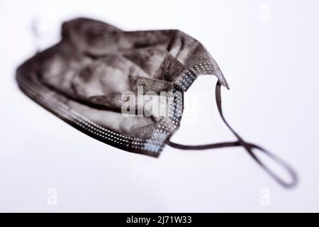 Verdreckte, von der Strasse aufgelesene medizinische Maske, Studioaufnahme, Koeln, Nordrhein-Westfalen, Germania Foto Stock