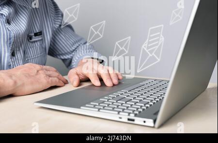 Concetto di posta aziendale. Uomo che lavora su un notebook e invia lettere a partner, colleghi. Comunicazione online. Foto di alta qualità Foto Stock