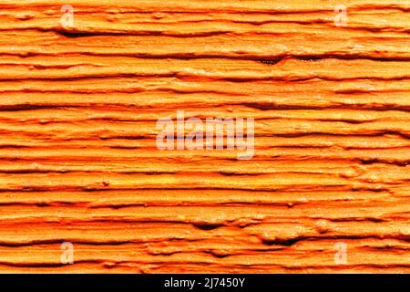 Lotto di tratti spessi paralleli di vernice arancione su tela. Trama astratta con struttura di linea Foto Stock