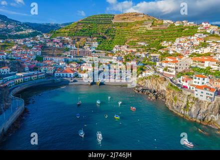 Vista aerea del drone di Camara de Lobos villaggio panorama vicino a Funchal, Madeira. Piccolo villaggio di pescatori con molte piccole barche in una baia Foto Stock