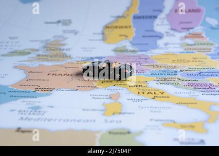 TOY car on Europe map, sitting view, Travel concept, mini green sport car going to France, Worldwide tour, Europe map idea Foto Stock