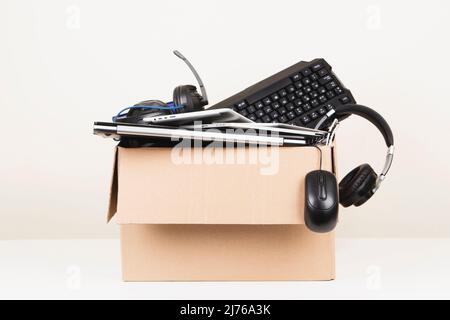 Scatola di cartone piena vecchi computer usati e dispositivi gadget per il riciclaggio.e-rifiuti, donazione, rifiuti elettronici per il riutilizzo e il riciclaggio concetto Foto Stock