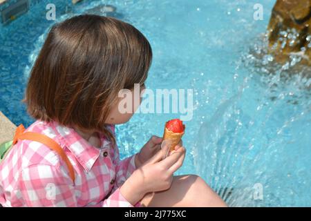 Contiene un cono di waffle freschi con gelato al lampone Foto Stock