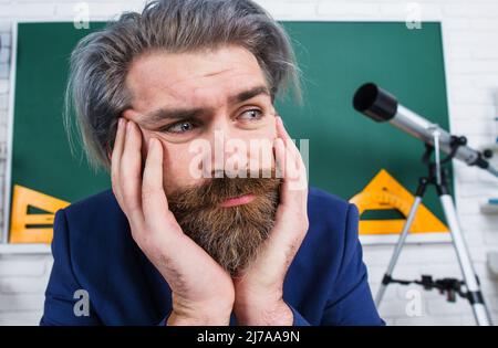 Insegnante con bistrò in classe. Torna a scuola. Giornata degli insegnanti. Professore premuroso in classe. Foto Stock