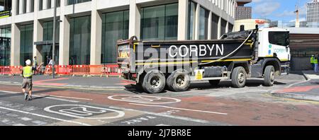 Vista laterale di Corbyn Groundwork & Foundation business hgv Truck ribaltabili su strada principale banksman arresto traffico East London Inghilterra UK Foto Stock