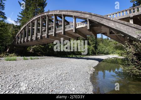Il ponte ad arco legato abbandonato attraversa il fiume Van Duzen, colpito dalla siccità, lungo l'autostrada statale 36 nella California settentrionale. Foto Stock
