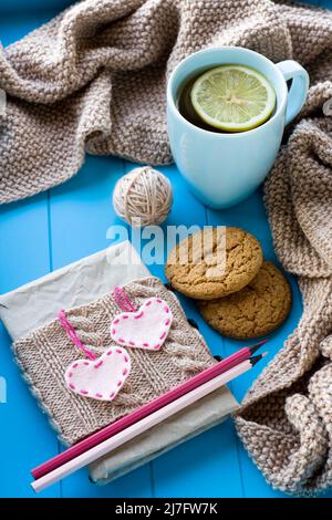 Aghi da maglia con cuori sullo sfondo di uncinetto, sfondo grigio Foto stock  - Alamy