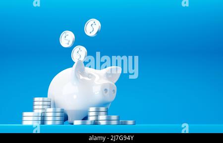 Banca bianca del piggy con le monete di dollaro d'argento cadenti ed il mucchio delle monete Foto Stock