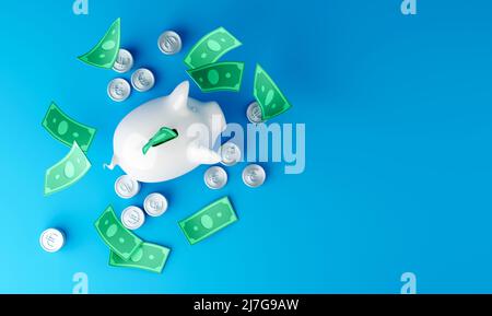 Banca bianca del piggy con le fatture e le monete del dollaro cadenti su sfondo blu Foto Stock