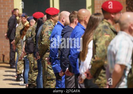 Altheim, Germania. 09th maggio 2022. I membri della Bundeswehr e i dipendenti civili si trovano sul sito del deposito di munizioni Altheim vicino a Walldürn durante la rimessa in servizio del cerimoniale. Come parte del riorientamento della Bundeswehr alla difesa nazionale e alleata, il deposito delle munizioni e il vicino deposito di Hardheim sono stati rimessi in servizio. Credit: Frank Rumpenhorst/dpa/Alamy Live News Foto Stock