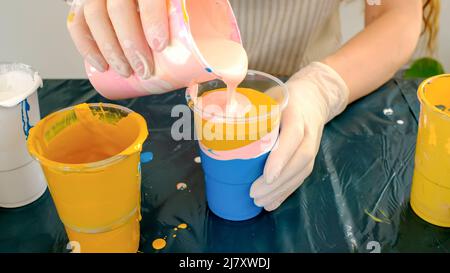 Tecnica Fluid ART. L'artista femminile lavora sulla pittura astratta di arte fluida. Foto Stock