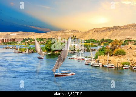 Barche a vela di fronte alle colline del Nilo ad Assuan, Egitto Foto Stock