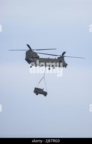 Viste da Yelland Quay nel North Devon come Chinook militare esercizio volare da RMB Chivenor su Braunton Burrows. L'elicottero è stato visto trasportare un Landrover Defender e Trailer avanti e indietro dal Braunton Burrows a RMB Chivenor, Devon, Regno Unito caratterizzato: View, Royal Marines dove: Yelland, Devon, Regno Unito quando: 24 Mar 2021 credito: Upright medial/WENN Foto Stock