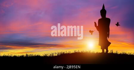 Silhouette di Buddha mediante al crepuscolo con sfondo alba. Magha Puja, Asanha Puja e Visakha Puja giorno. Concetto di vacanza buddista. Foto Stock