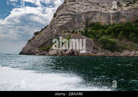 Spruzzi d'acqua da una barca galleggiante. Mar Nero, giorno d'estate. Foto Stock