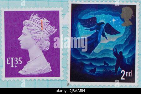 Foto di due francobolli inglesi un francobollo fucsia del valore di £1,35 e un francobollo di Natale di classe 2nd con l'angelo Gabriel da una serie nel 2019 Foto Stock