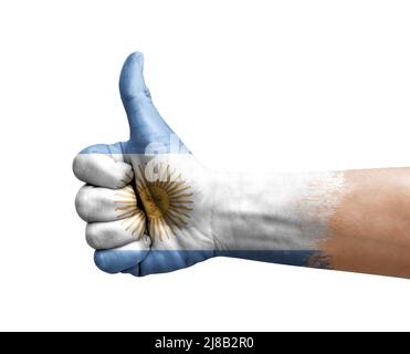 Mano facendo pollice su dipinto con bandiera dell'argentina Foto Stock