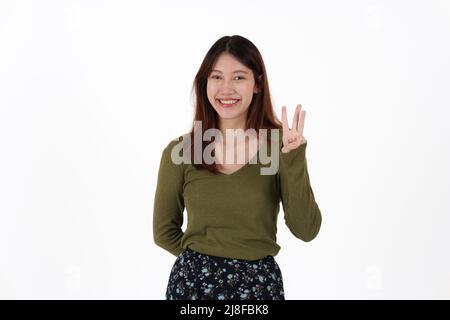 Immagine di ragazza felice in piedi e guardando fotocamera che punta isolato su sfondo bianco. Foto Stock