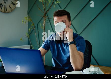 Uomo scioccato dalle notizie, uomo wirh sorpresa emozione guardando lo schermo del laptop, lavorando a casa Foto Stock