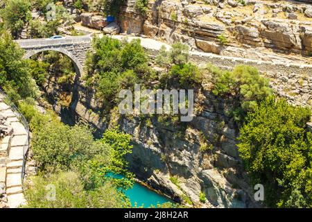 Antico ponte romano sulla gola del fiume Koprucay nel Parco Nazionale di Koprulu in Turchia. Foto Stock