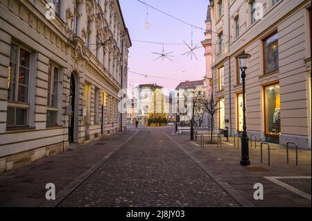 LUBIANA, SLOVENIA - 01 GENNAIO 2022: Strade di Lubiana durante le vacanze di Natale con ornamenti e luci festive. Foto Stock