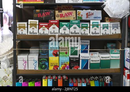 Prodotti del tabacco e sigarette, compresi i mentoli in pacchetti verdi, esposti per la vendita in un piccolo minimarket nel quartiere Queens di New York City, NY, 17 maggio 2022. La FDA ha annunciato che intende vietare le sigarette mentolo a causa di tassi più elevati di affezione e morte affumicanti nelle comunità afro-americane dove sono fortemente pubblicizzati, così come i sigari aromatizzati popolari tra i fumatori più giovani; il mentolo chimico aggiunto alle sigarette riduce l'irritazione della gola associata al fumo. (Foto di Anthony Behar/Sipa USA) Foto Stock