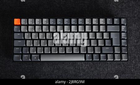 LONDRA - 11 APRILE 2022: Tastiera per computer meccanica Keychron in grigio scuro vista dall'alto sfondo Foto Stock