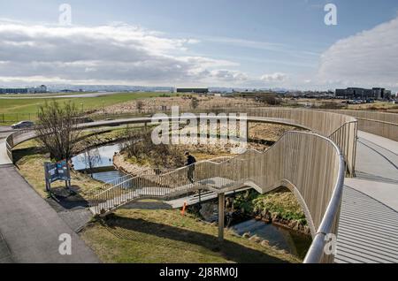 Reykjavik, Islanda, 25 aprile 2022: Cavalcavia pedonale dal design stilistico con l'aeroporto nazionale di Vatnsmyri sullo sfondo Foto Stock