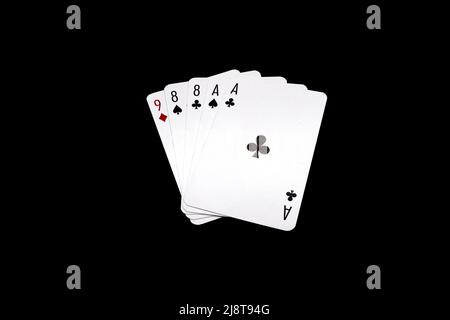 Due coppie di eights e assi 'mano di mans' poker isolato su sfondo nero Foto Stock