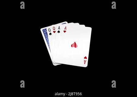 Due coppie di regine e assi con una carta rovesciata. Mano di poker isolato su sfondo nero Foto Stock