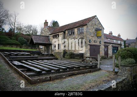 Un'ottima passeggiata per raggiungere un ottimo pub: Il Fauconberg Arms, Coxwold, North Yorkshire. Il centro visitatori Mouseman a Kilburn di proprietà dell'artigiano locale Robert Tho Foto Stock