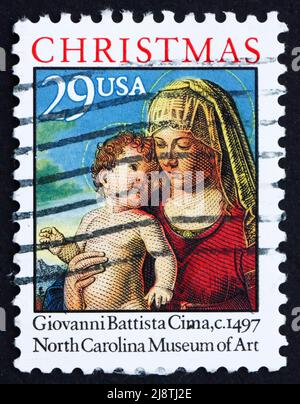 STATI UNITI D'AMERICA - CIRCA 1993: Un francobollo stampato negli Stati Uniti mostra Madonna col Bambino in un paesaggio di Giovanni Battista cima, Natale, circa 1 Foto Stock