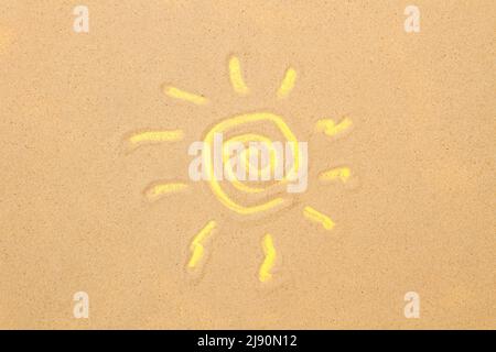 Il sole si disegna sulla sabbia e su sfondo giallo Foto Stock